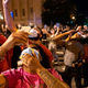Protestors look up as a military helicopter flies low onto the crowd.